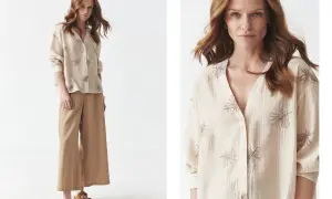 Kobieta w beżowej koszuli z haftowanymi liśćmi i szerokich spodniach, styl cottagecore.